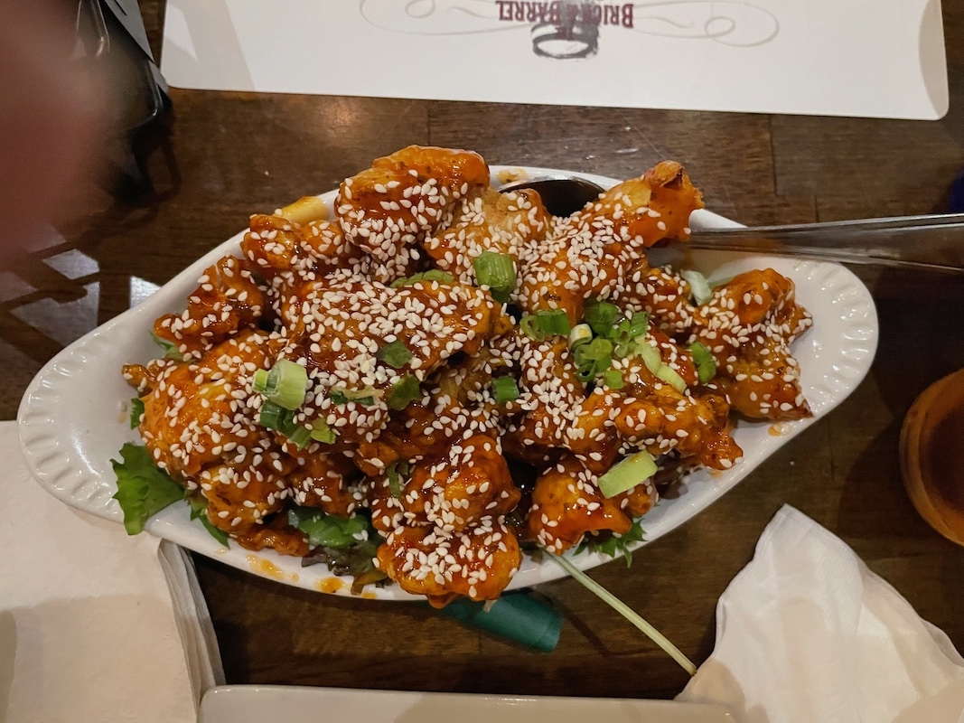 Firecracker cauliflower tossed in sweet and spicy sauce with sesame seeds
