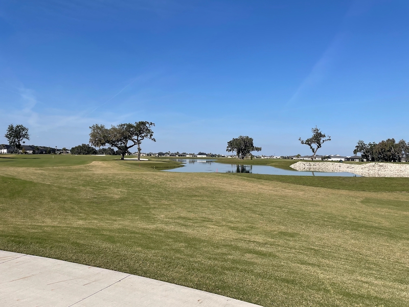 Wide fairway and water view at Woodlands Golf Course The Villages